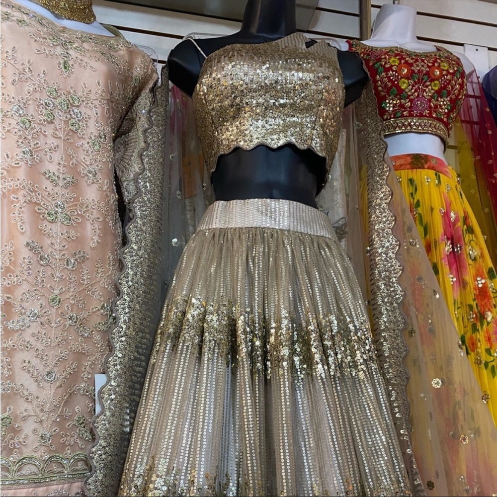 Champagne Gold sequin lehenga with dupatta. Muted grey tone fabric.